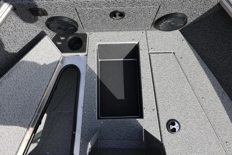 Slide: The Image of Interior view of 2026 Lund 1875 Impact XS Sport boat, featuring storage compartments and speakers. - 48