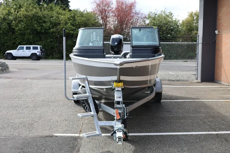 Slide: The Image of 2026 Lund 1875 Impact XS Sport boat on trailer in parking lot. - 5