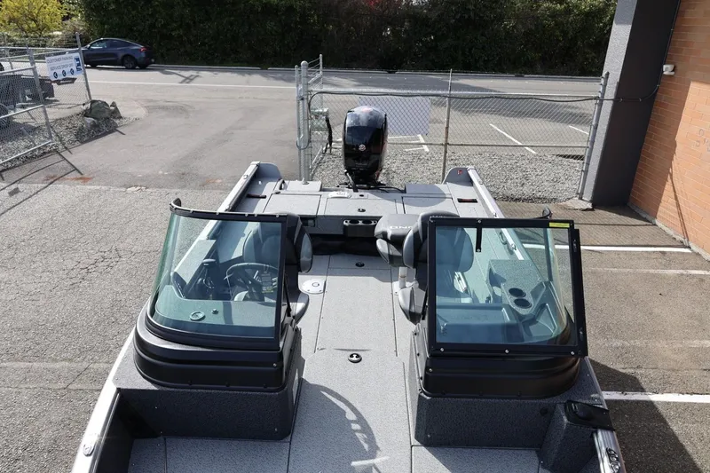Slide: The Image of 2026 Lund 1875 Impact XS Sport boat in parking lot, showcasing interior and windshield. - 50