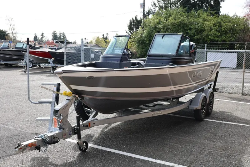 Slide: The Image of 2026 Lund 1875 Impact XS Sport boat on trailer in outdoor lot. - 7