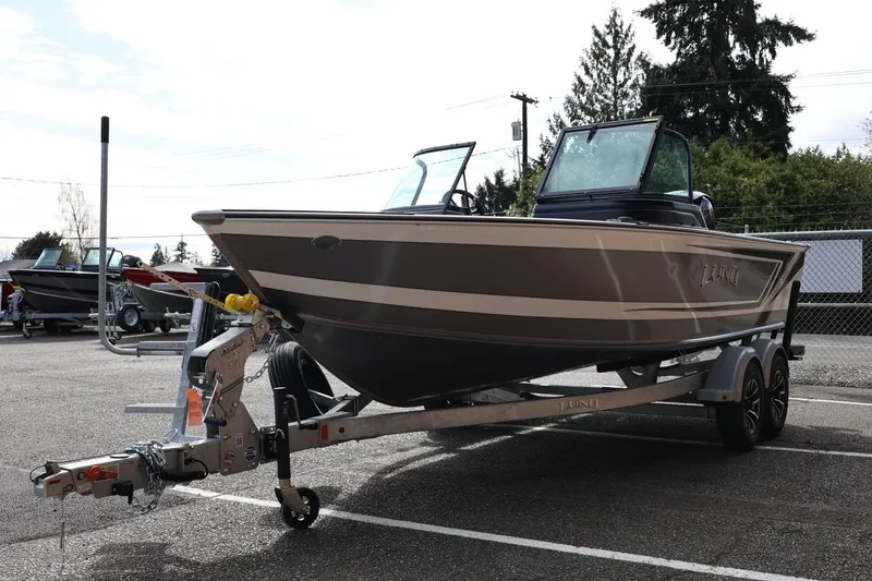 Slide: The Image of 2026 Lund 1875 Impact XS Sport boat on trailer in parking lot. - 8