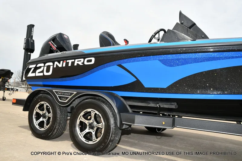 Slide: The Image of 2023 Nitro Z20 Pro boat with sleek blue design on trailer. - 20