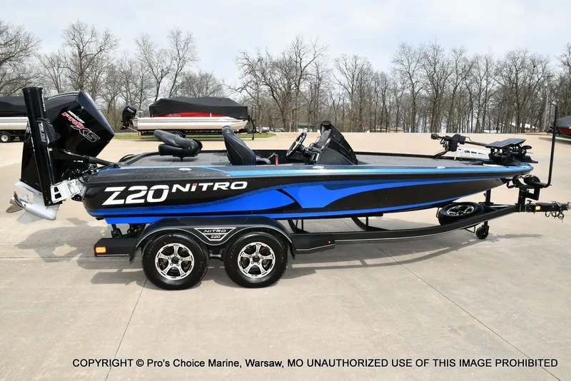 Slide: The Image of 2023 Nitro Z20 Pro boat on trailer, blue and black, side view. - 23