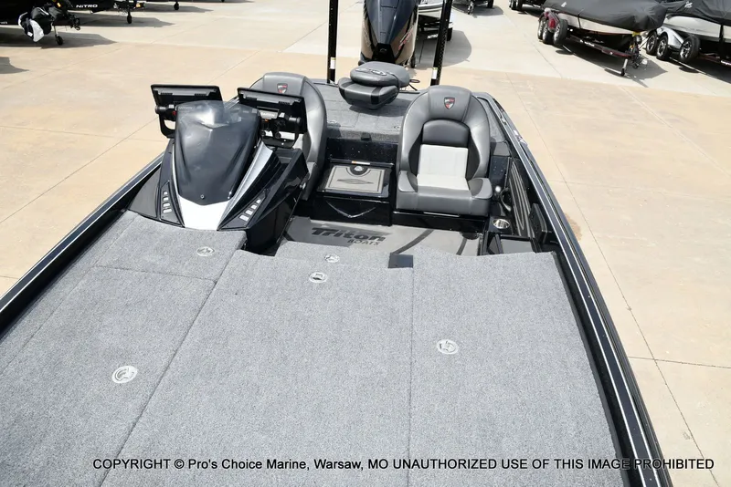 Slide: The Image of 2025 Triton 21XP boat with gray interior on a parking lot. - 14
