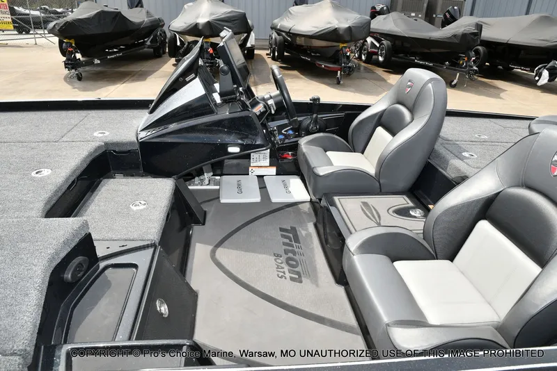 Slide: The Image of Interior of Triton 21XP boat, 2025 model, featuring gray seating. - 17