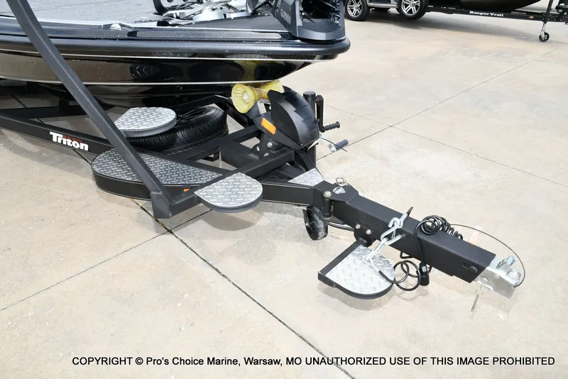 Slide: The Image of Triton 21XP 2025 boat trailer on concrete surface. - 32