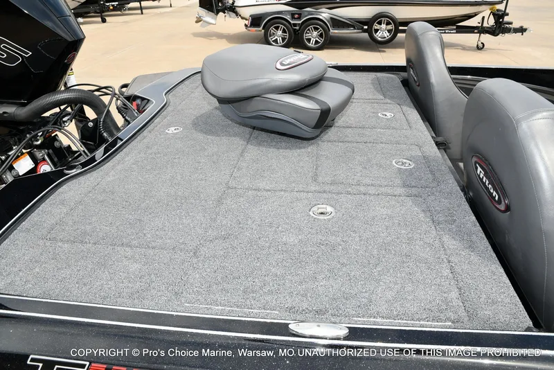 Slide: The Image of Triton 21XP 2025 boat with gray carpeted deck and seats. - 38