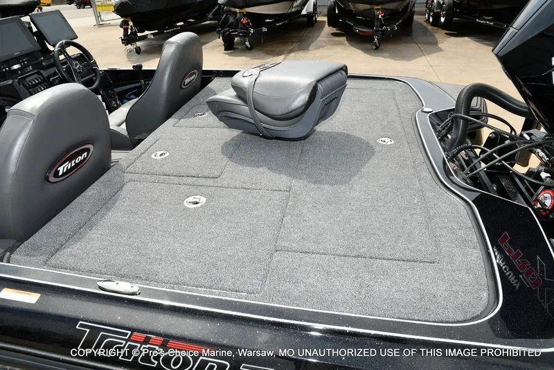 Slide: The Image of Interior of a 2025 Triton 21XP boat with gray seating. - 40