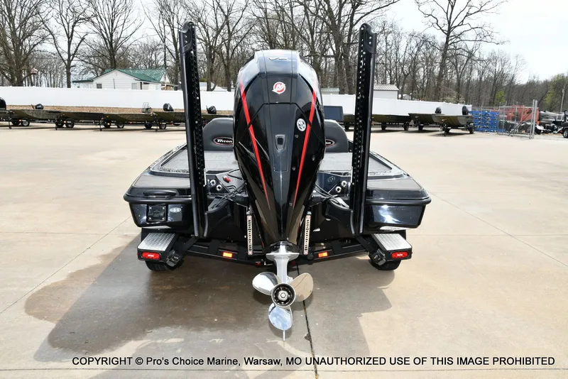 Slide: The Image of Rear view of a 2025 Triton 21XP boat on a parking lot. - 9