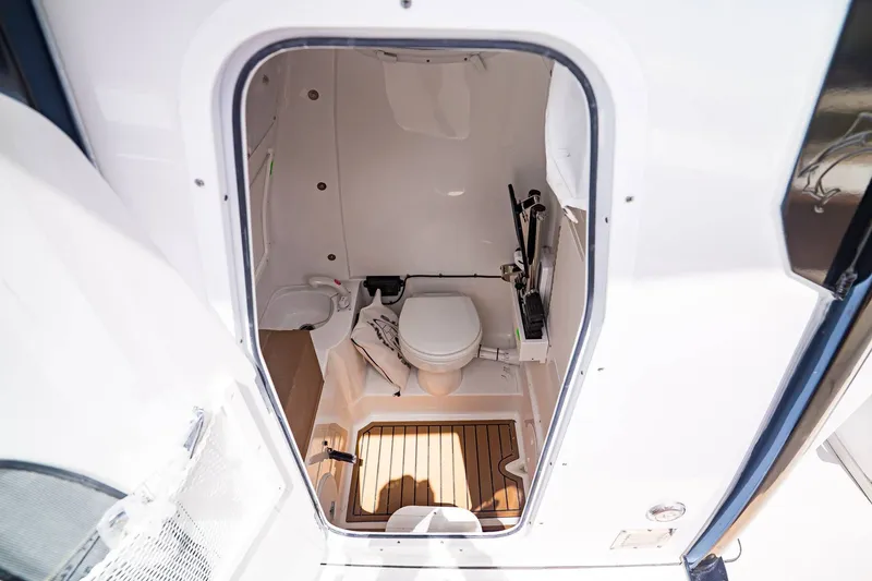 Slide: The Image of Interior view of Sea Hunt ULTRA 285CB 2026 boat toilet. - 19