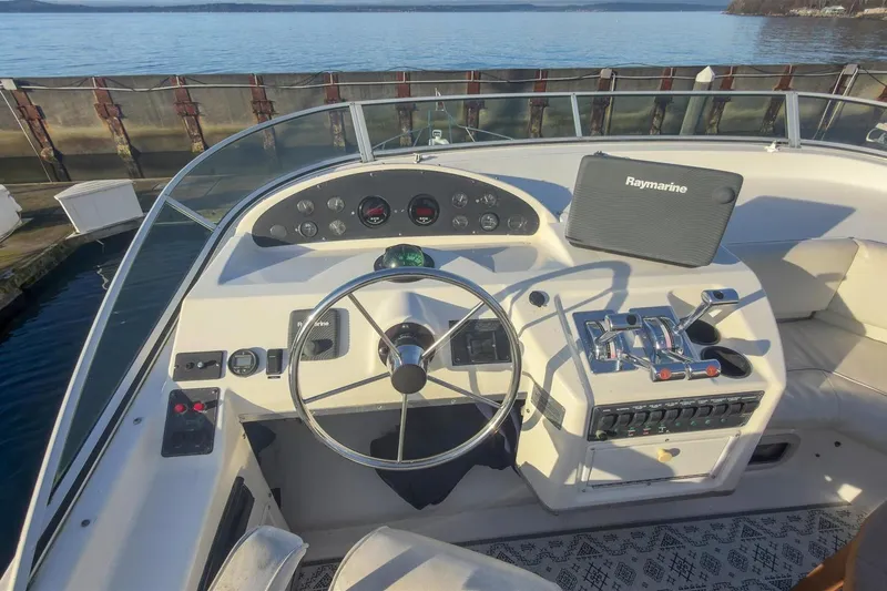 Slide: The Image of 2002 Bayliner 3988 Command Bridge Motoryacht helm with Raymarine navigation system. - 13