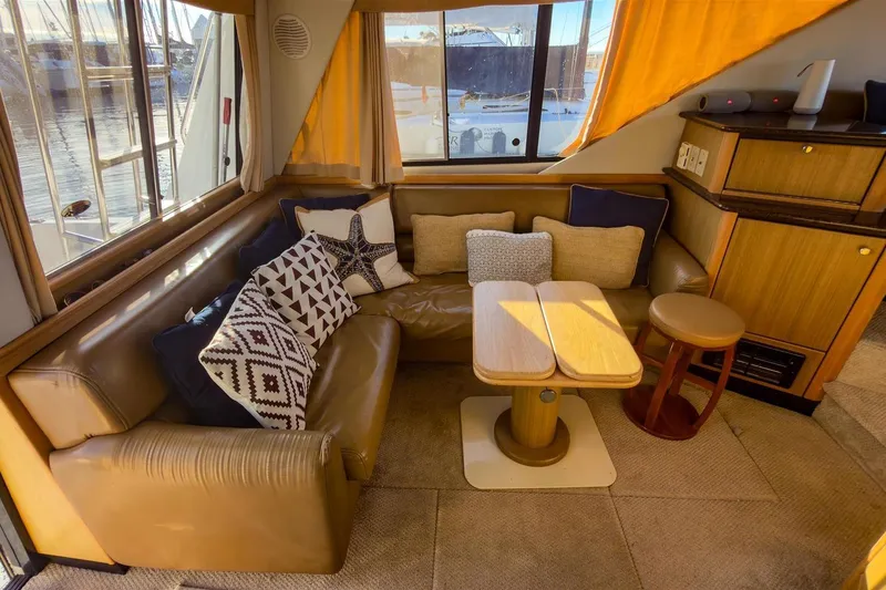 Slide: The Image of Interior of 2002 Bayliner 3988 Command Bridge Motoryacht with cozy seating and cushions. - 15