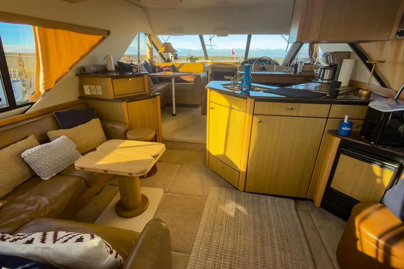 Slide: The Image of Interior of 2002 Bayliner 3988 Command Bridge Motoryacht with cozy seating and kitchen area. - 16