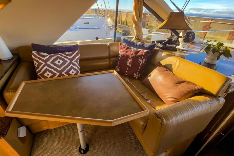 Slide: The Image of Cozy interior of 2002 Bayliner 3988 Command Bridge Motoryacht with cushions and table. - 18