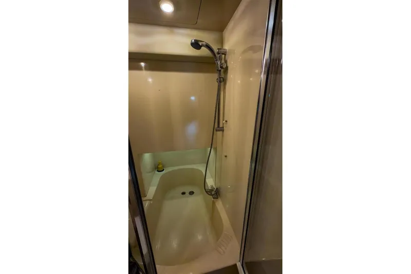 Slide: The Image of 2002 Bayliner 3988 Command Bridge Motoryacht shower with handheld showerhead and enclosed space. - 33