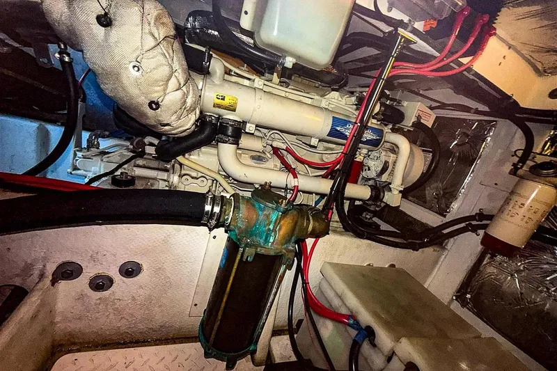 Slide: The Image of Engine room of 2002 Bayliner 3988 Command Bridge Motoryacht, showcasing mechanical components and wiring. - 38