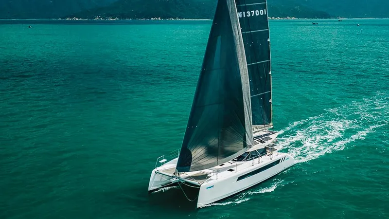 The Image of 2025 Seawind 1370 catamaran sailing on turquoise waters. - 0