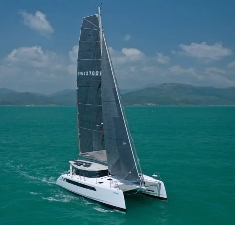 Slide: The Image of 2025 Seawind 1370 catamaran sailing on turquoise waters under a clear sky. - 2