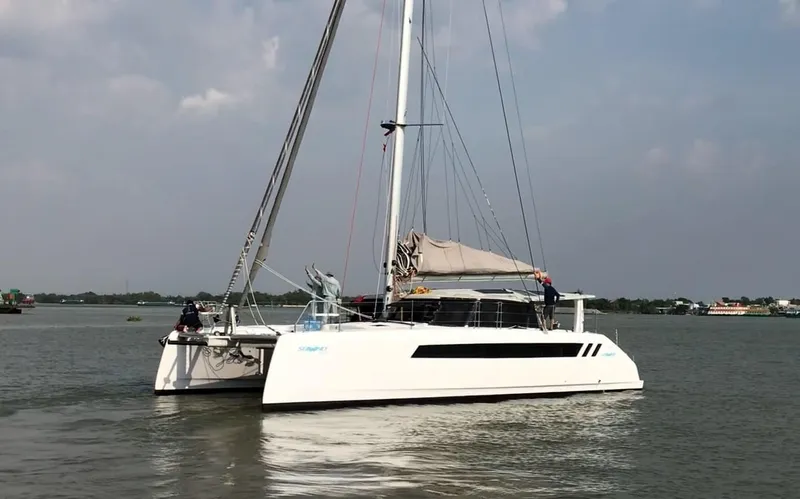 Slide: The Image of 2025 Seawind 1370 catamaran sailing on calm waters. - 3