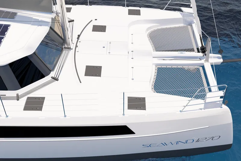 Slide: The Image of 2026 Seawind 1270 catamaran deck view with netting over blue water. - 10