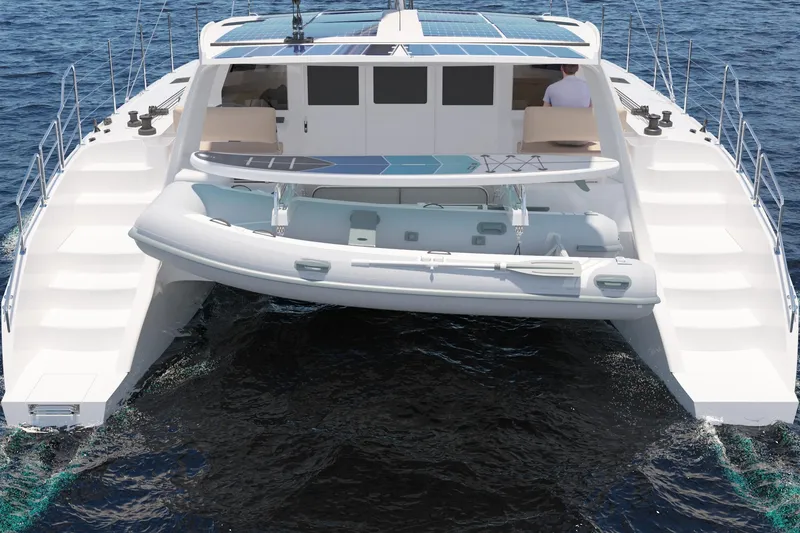 Slide: The Image of 2026 Seawind 1270 catamaran with paddleboard and dinghy on the ocean. - 13