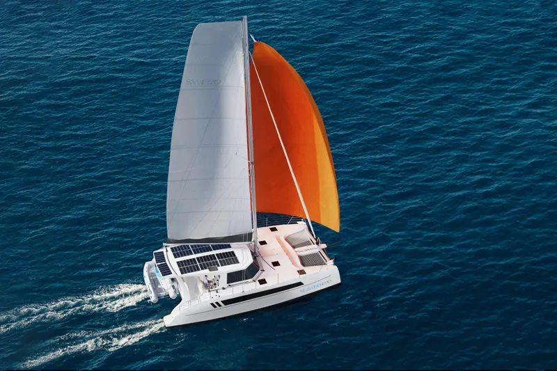 Slide: The Image of 2026 Seawind 1270 catamaran sailing with orange sail on blue ocean. - 6