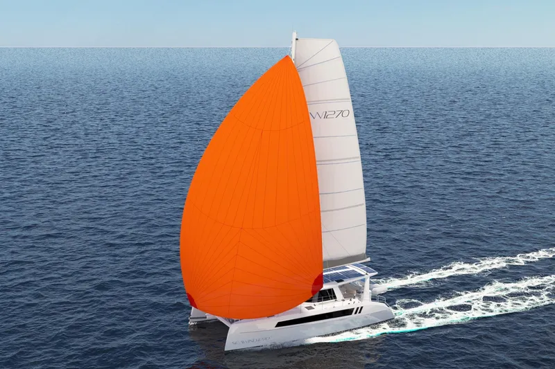Slide: The Image of 2026 Seawind 1270 catamaran sailing with vibrant orange spinnaker on open sea. - 7
