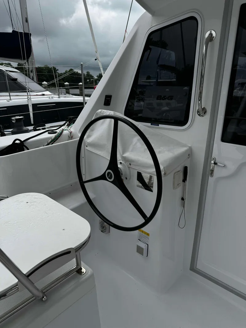 Slide: The Image of Steering wheel of a 2023 Seawind 1160 Lite catamaran. - 10