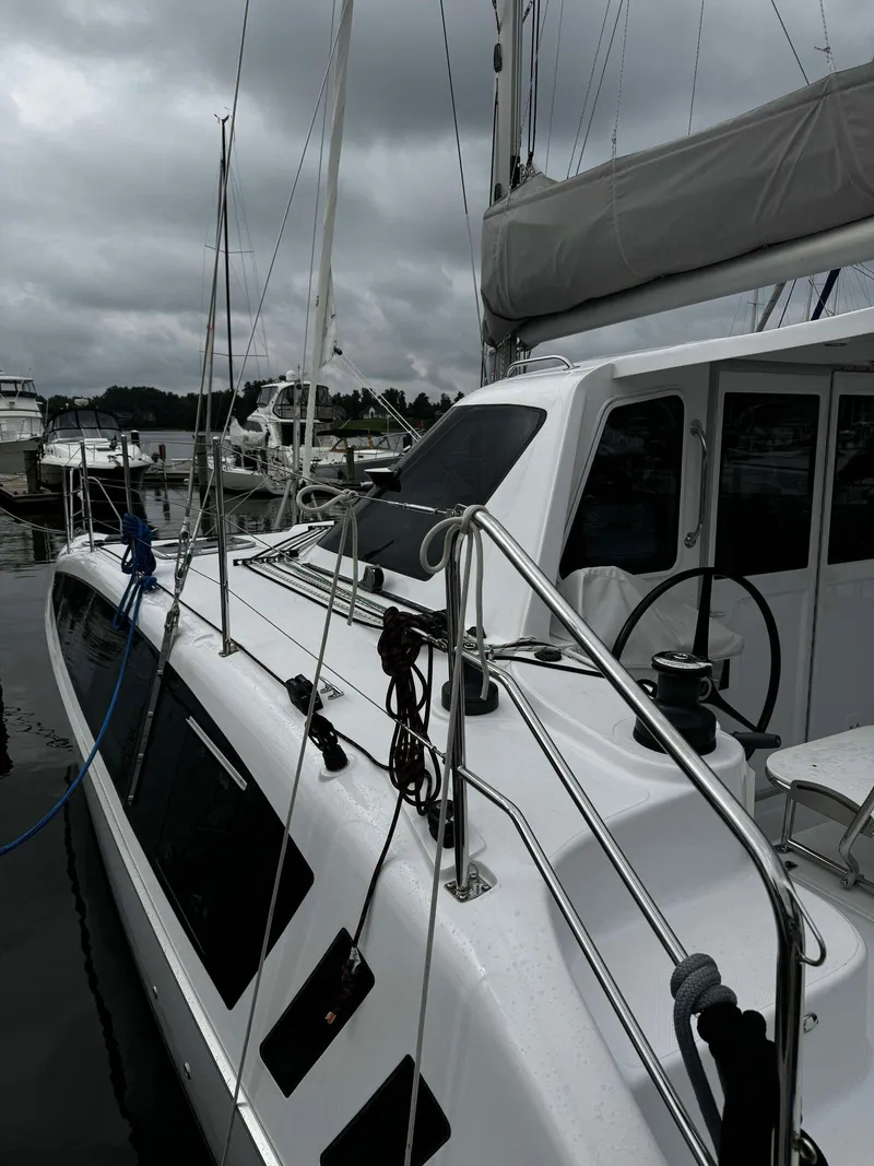 Slide: The Image of 2023 Seawind 1160 Lite catamaran docked at a marina. - 12
