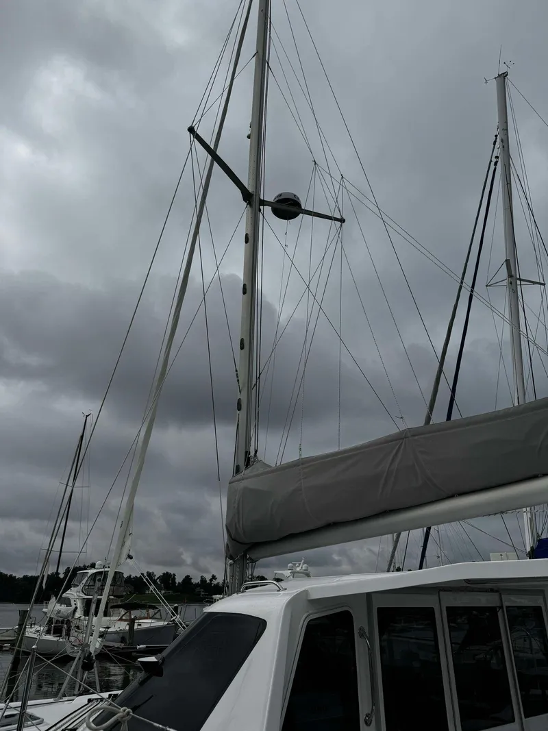 Slide: The Image of Seawind 1160 Lite 2023 catamaran docked under cloudy skies. - 13