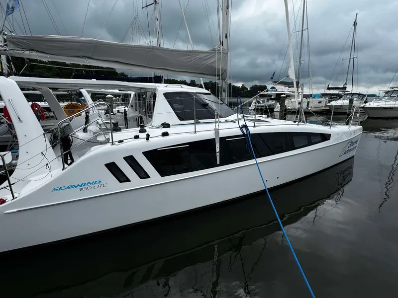 Slide: The Image of 2023 Seawind 1160 Lite catamaran docked in a marina. - 3