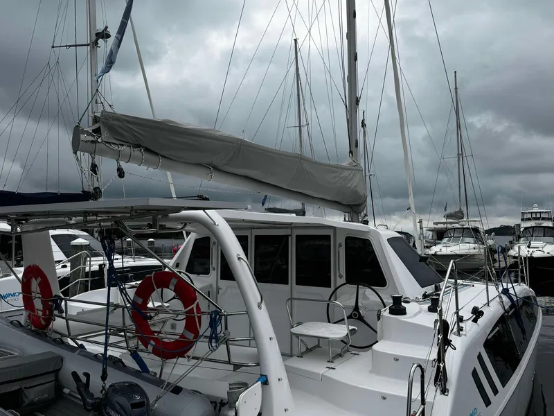 Slide: The Image of 2023 Seawind 1160 Lite catamaran docked at marina under cloudy sky. - 6