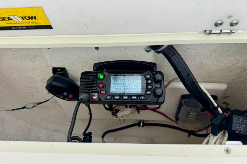 Slide: The Image of Marine radio equipment inside a 2016 Sea Hunt Ultra 234 boat compartment. - 11
