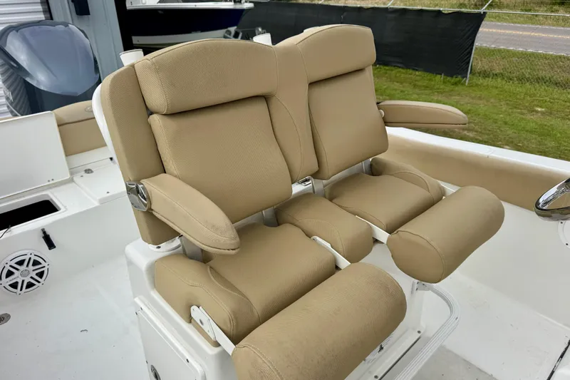 Slide: The Image of 2016 Sea Hunt Ultra 234 boat with beige cushioned seats and armrests. - 12