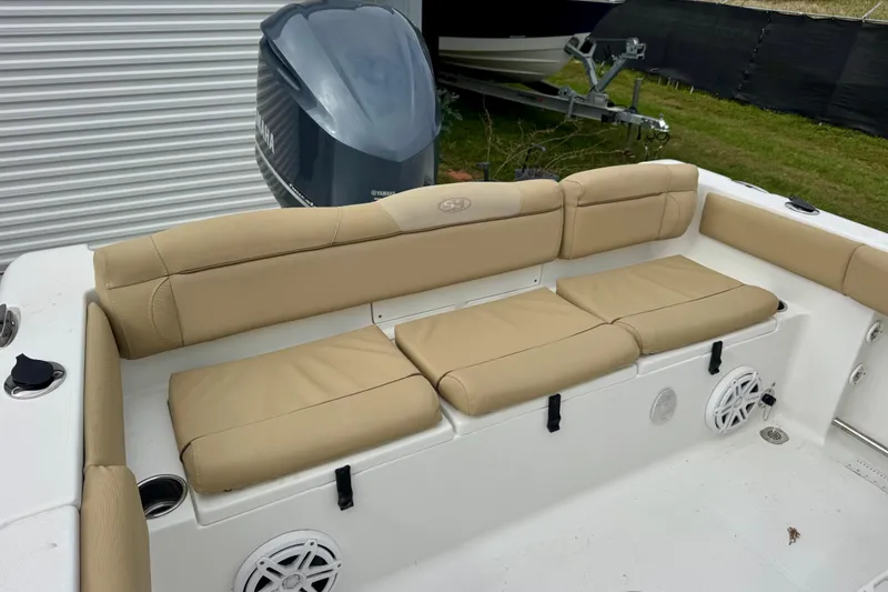 Slide: The Image of 2016 Sea Hunt Ultra 234 boat with beige seating and Yamaha engine. - 6