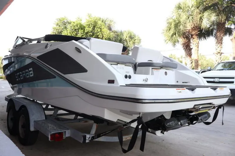 Slide: The Image of 2023 Scarab 255 ID boat on trailer, side view. - 2