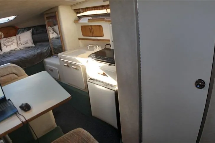 Slide: The Image of Interior of 1993 Sea Ray 290 Sundancer boat with kitchenette and sleeping area. - 15
