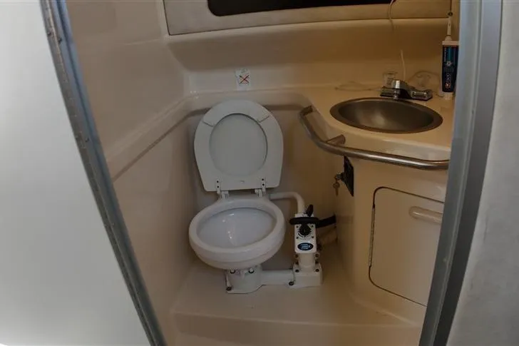 Slide: The Image of 1993 Sea Ray 290 Sundancer bathroom with toilet and sink. - 20