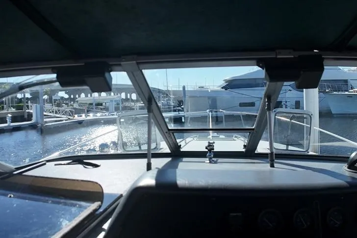 Slide: The Image of Interior view from a 1993 Sea Ray 290 Sundancer boat docked at a marina. - 21