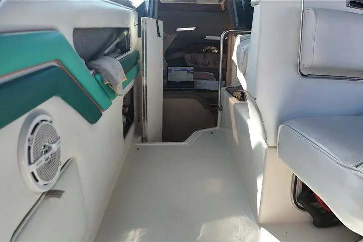 Slide: The Image of Interior view of 1993 Sea Ray 290 Sundancer boat with seating and cabin entrance. - 23