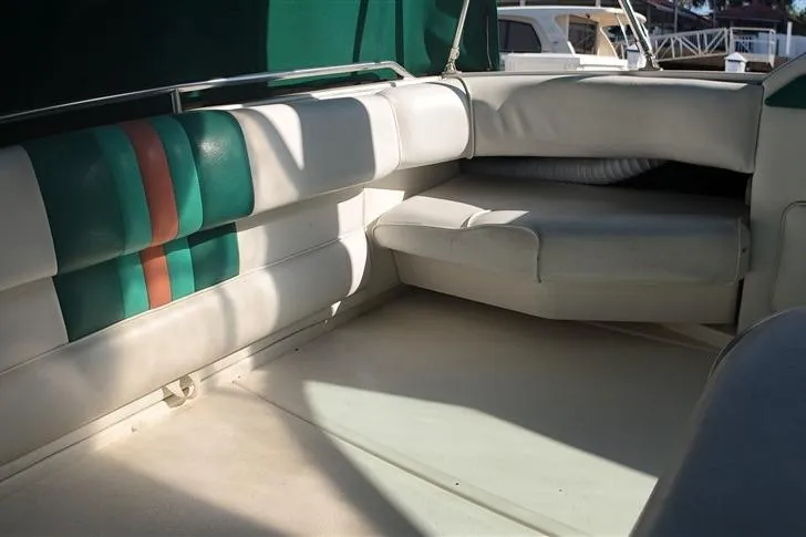 Slide: The Image of Interior seating of a 1993 Sea Ray 290 Sundancer boat with green and white upholstery. - 24