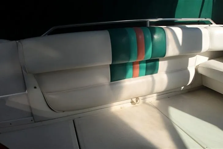 Slide: The Image of 1993 Sea Ray 290 Sundancer boat interior with white and green-striped seating. - 25