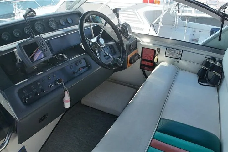 Slide: The Image of Cockpit of 1993 Sea Ray 290 Sundancer with steering wheel and control panel. - 27