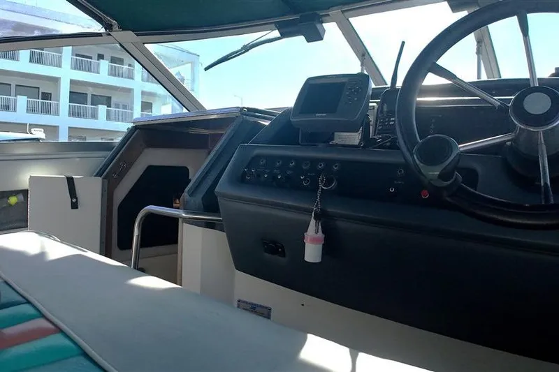 Slide: The Image of Interior view of 1993 Sea Ray 290 Sundancer boat cockpit with steering wheel and controls. - 28