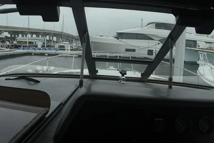 Slide: The Image of View from the helm of a 1993 Sea Ray 290 Sundancer in a marina. - 33