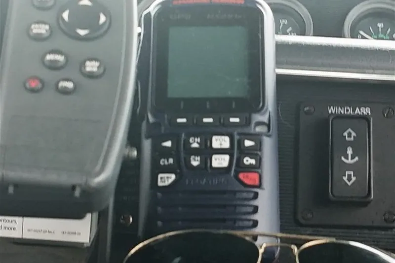 Slide: The Image of Control panel of a 1993 Sea Ray 290 Sundancer boat with radio and windlass switch. - 34