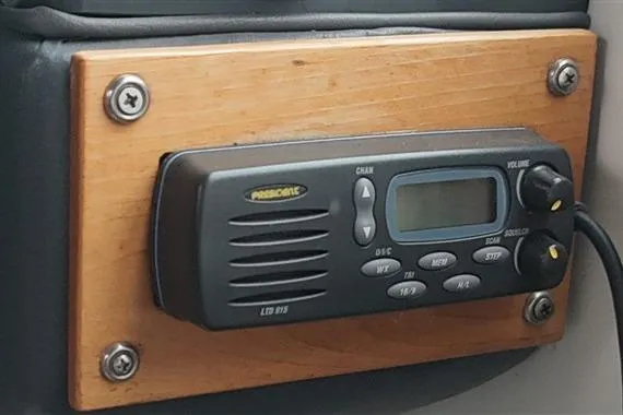 Slide: The Image of Marine radio mounted on a wooden panel in a 1993 Sea Ray 290 Sundancer boat. - 36