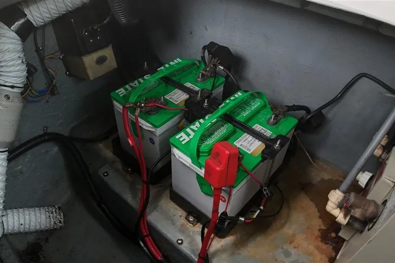 Slide: The Image of Two marine batteries in a 1993 Sea Ray 290 Sundancer engine compartment. - 38