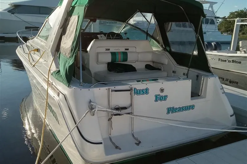 Slide: The Image of 1993 Sea Ray 290 Sundancer boat docked, featuring green canopy and "Just For Pleasure" text. - 4