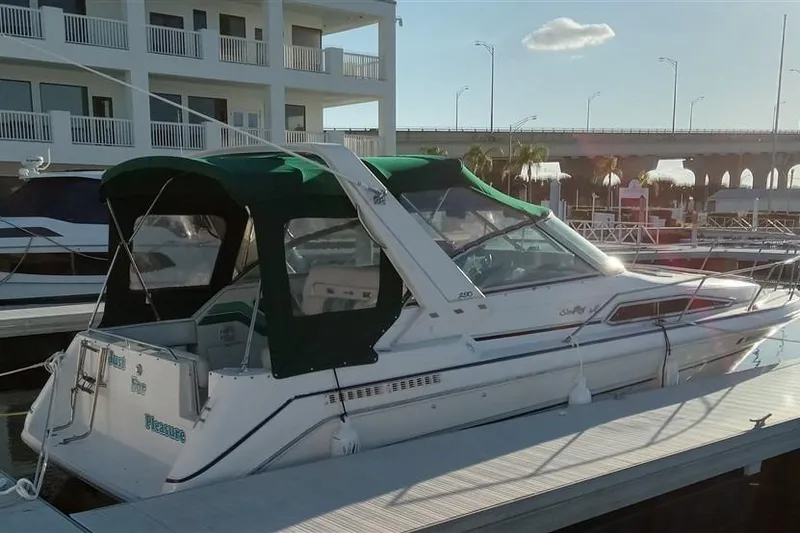 Slide: The Image of 1993 Sea Ray 290 Sundancer docked at marina with green canopy. - 9